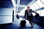 Businessman Running to Catch a Flight --- Image by © Larry Williams/CORBIS